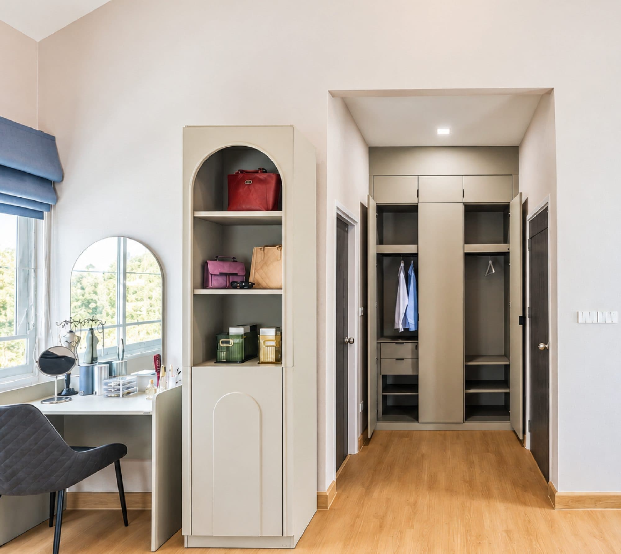 Dressing table and arched shelving, opening onto a wardrobe area.