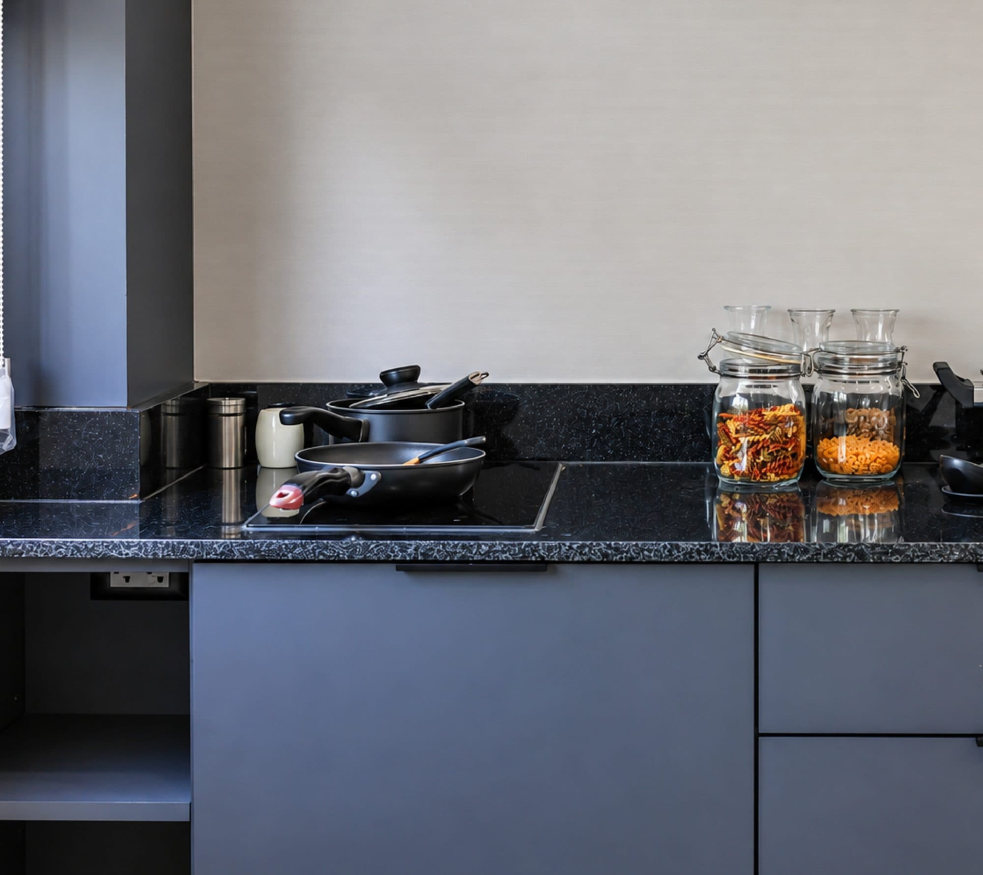 Black granite worktop and hob in the kitchen.