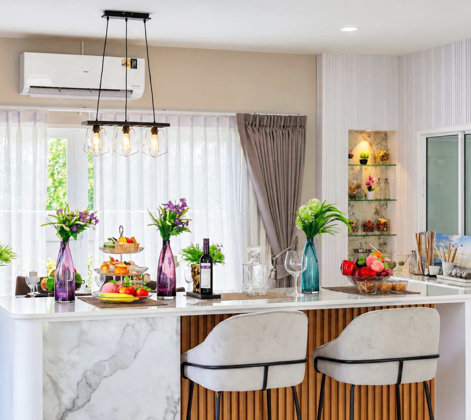 Marble kitchen island under pendant lights.