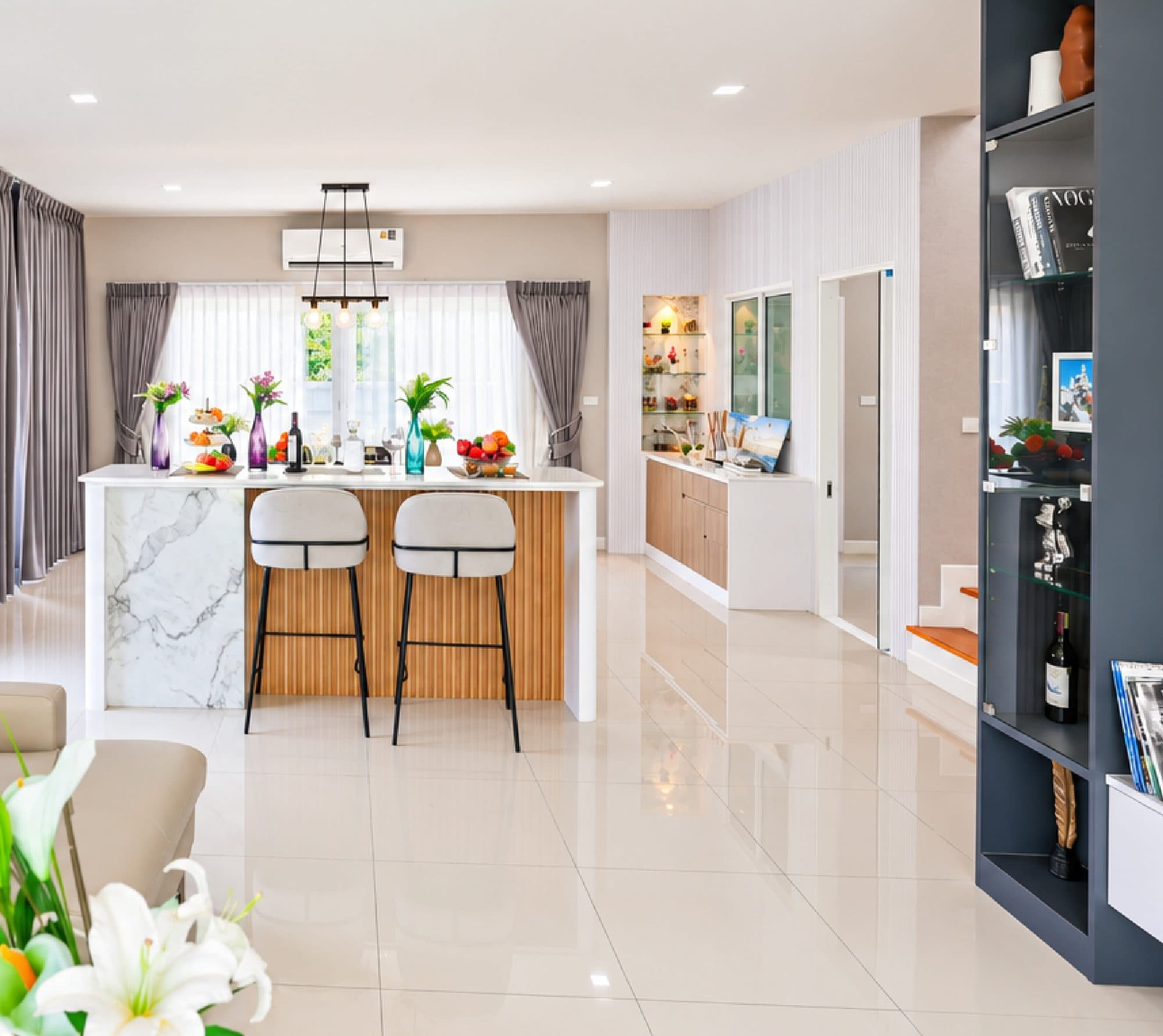 The marble kitchen island and bar stools, seen from the living room.