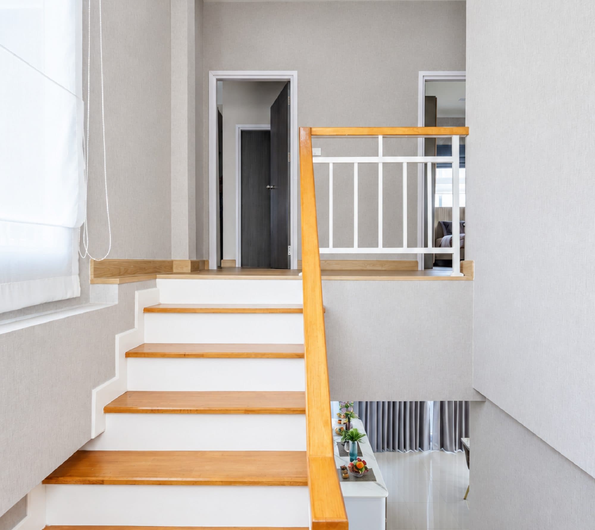 The stair up to the landing, with a timber handrail.
