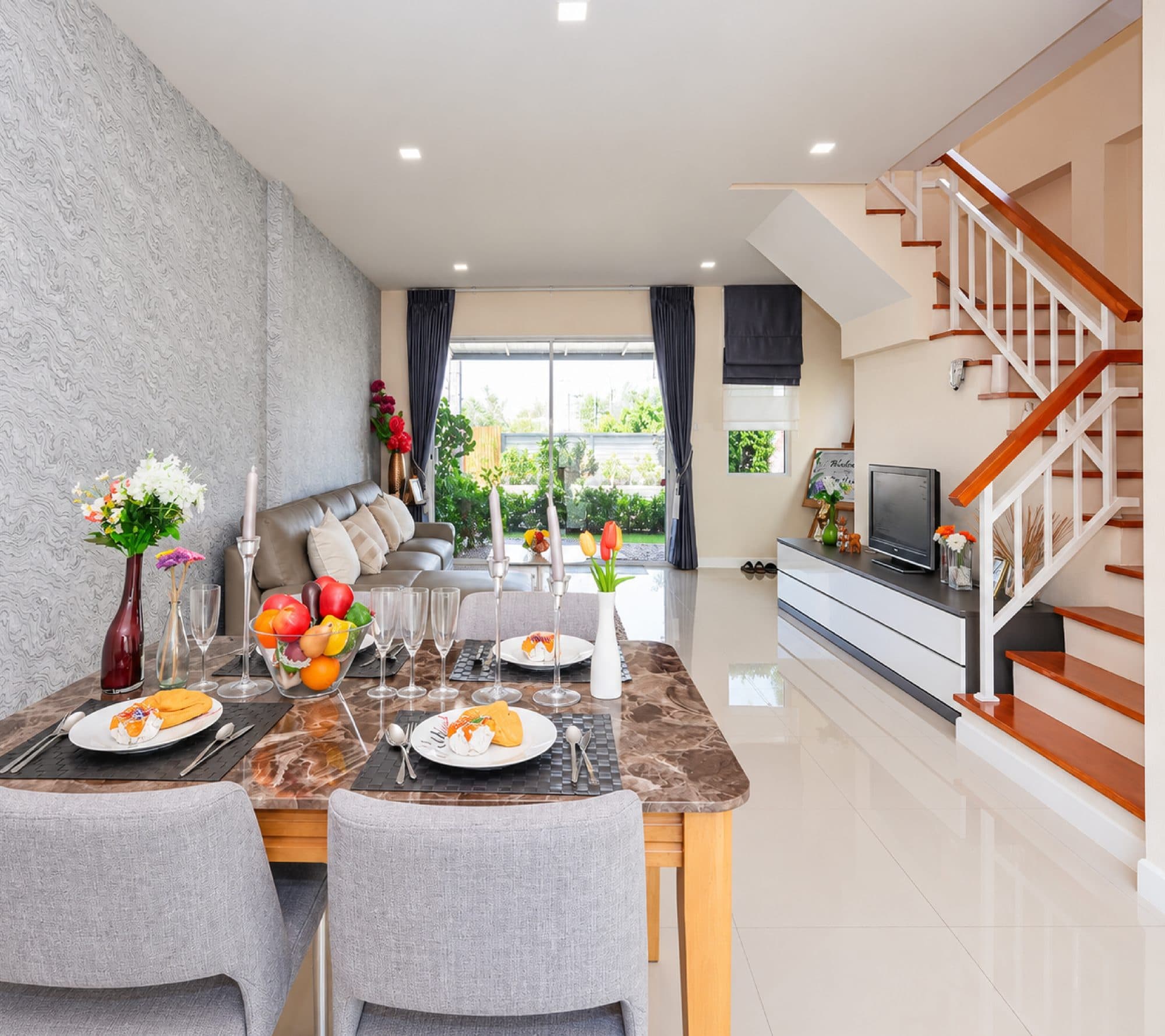 Marble-top dining table beside the timber stair.